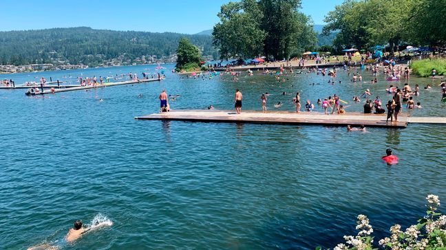 CORRECTS BYLINE TO LISA BAUMANN NOT CHRIS GRYGIEL People flock to Bloedel Donovan park at Lake Whatcom in Bellingham, Wash., during an uncharacteristic Pacific Northwest heat wave Sunday, June 26, 2021. Temperatures were expected to rise to 112 degrees in Portland, Oregon, on Sunday and 111 degrees at the Seattle-Tacoma International Airport on Monday. The heat wave was also moving into Idaho, where about 3,000 athletes were competing in an Ironman Triathlon in Coeur d'Alene. The event includes a 2.4 mile swim, a 112-mile bike ride and a 26.2-mile marathon run as temperatures top 100 degrees. (AP Photo/Lisa Baumann)